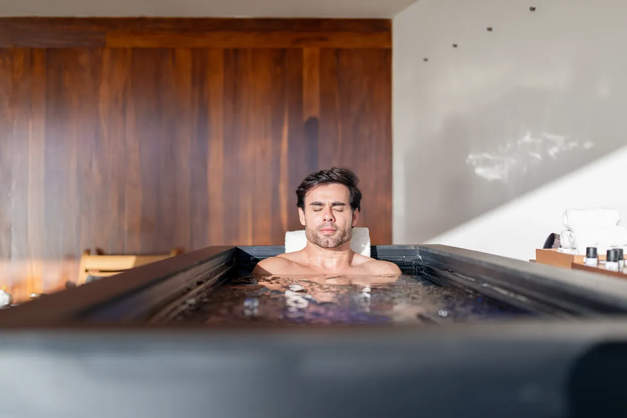 Man enjoying an ice bath wellness therapy session at Breathless Cabo San Lucas