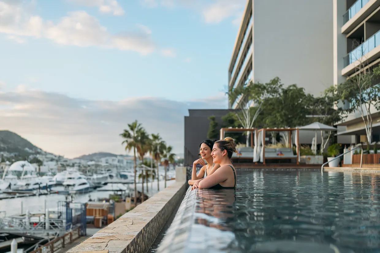 Guests relaxing in the marina-view infinity pool at Breathless Cabo San Lucas