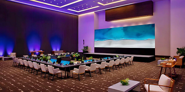 Ballroom reception setup with elegant lighting at Secrets Impression Moxché