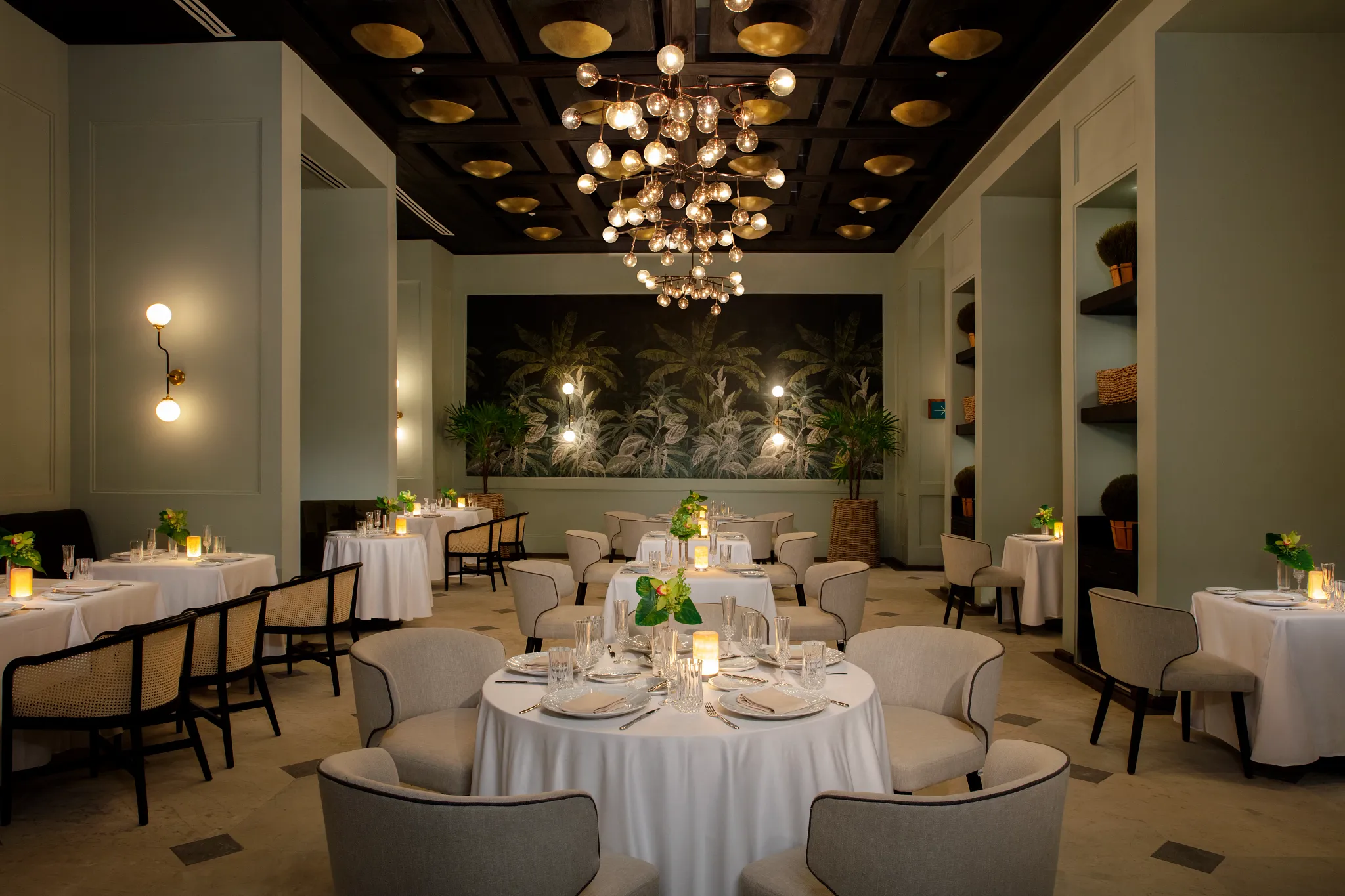 Bisou French restaurant at Impression Moxché by Secrets featuring elegant formal dining, crystal chandeliers, candlelit tables, and refined décor.