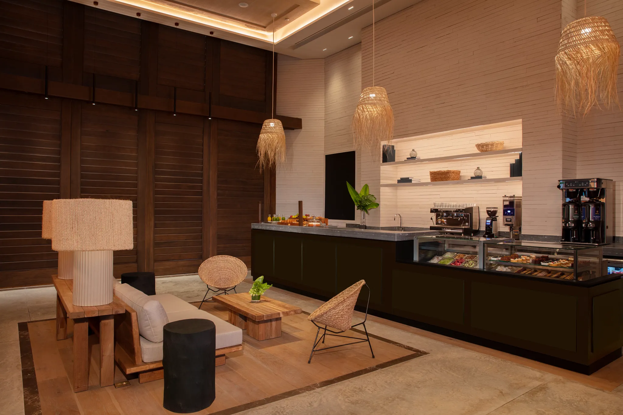 Coco Café at Impression Moxché by Secrets featuring a modern coffee bar, fresh pastries display, and cozy indoor lounge seating.