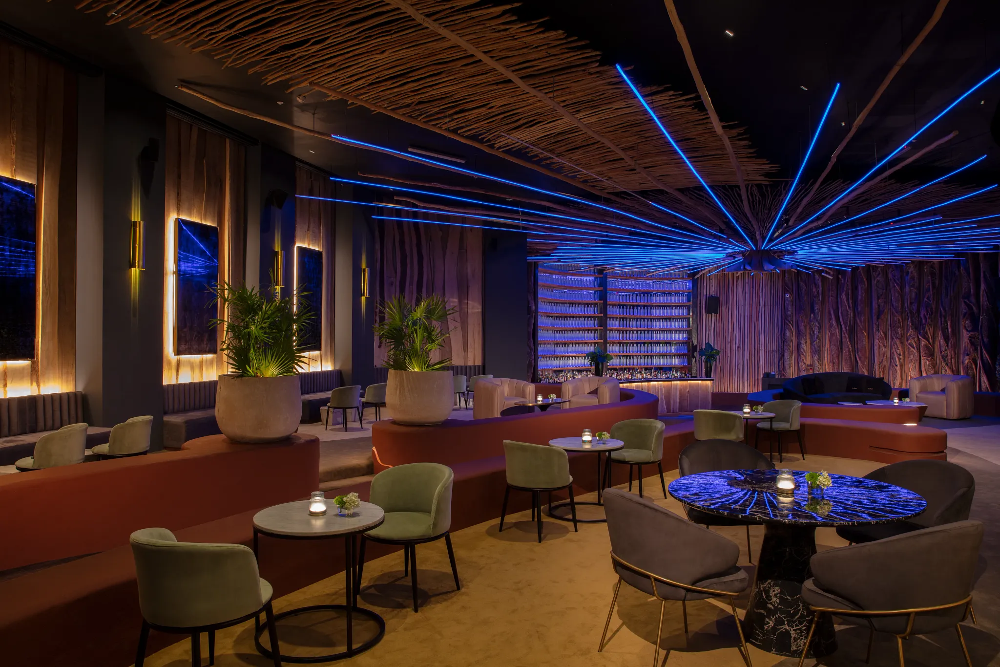 Gypsy nightclub at Impression Moxché by Secrets featuring modern lounge seating, neon ceiling lights, DJ booth, and vibrant dance floor.