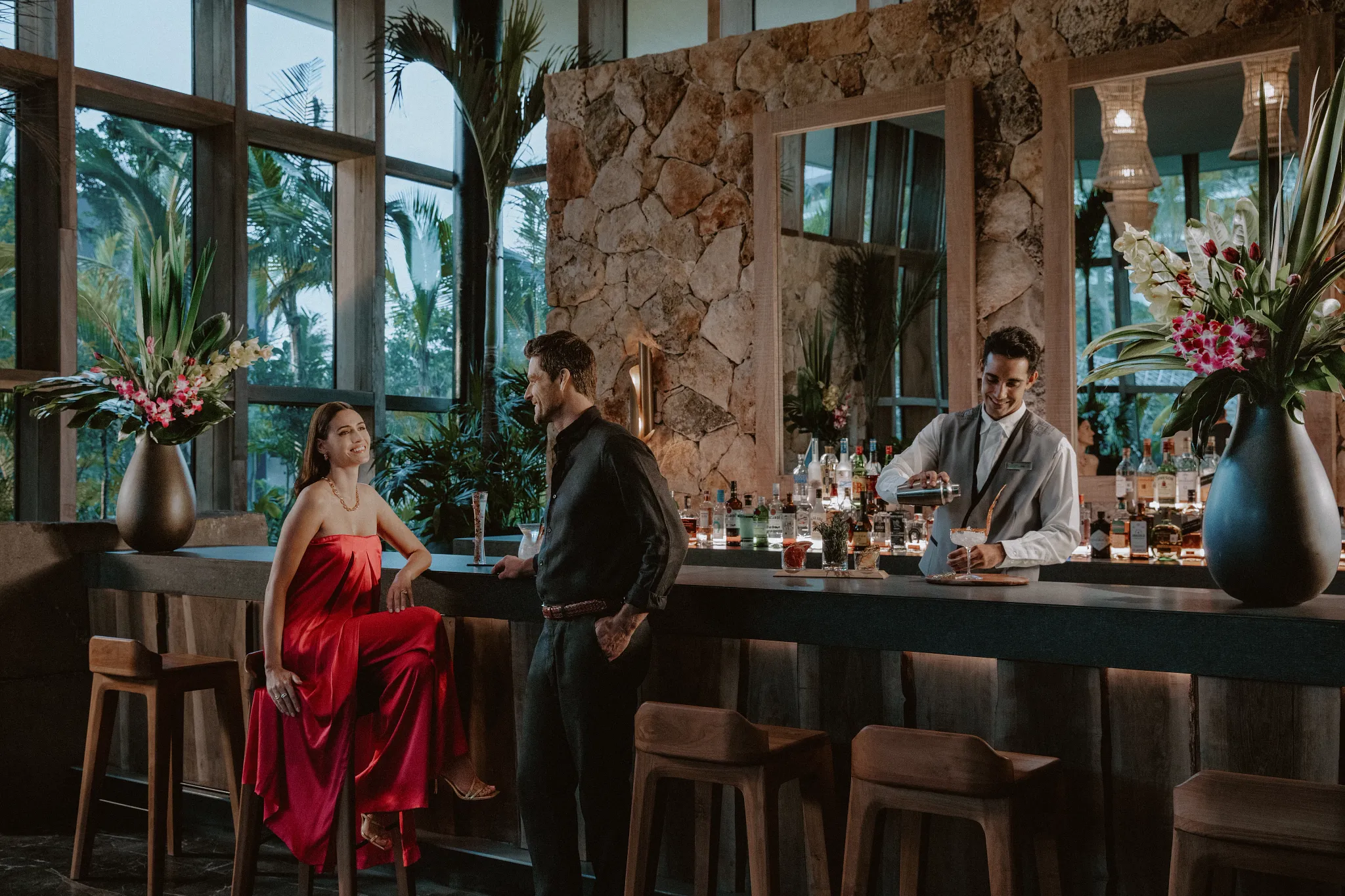 Elegant lobby bar atmosphere with couple enjoying drinks at Impression Moxché by Secrets.