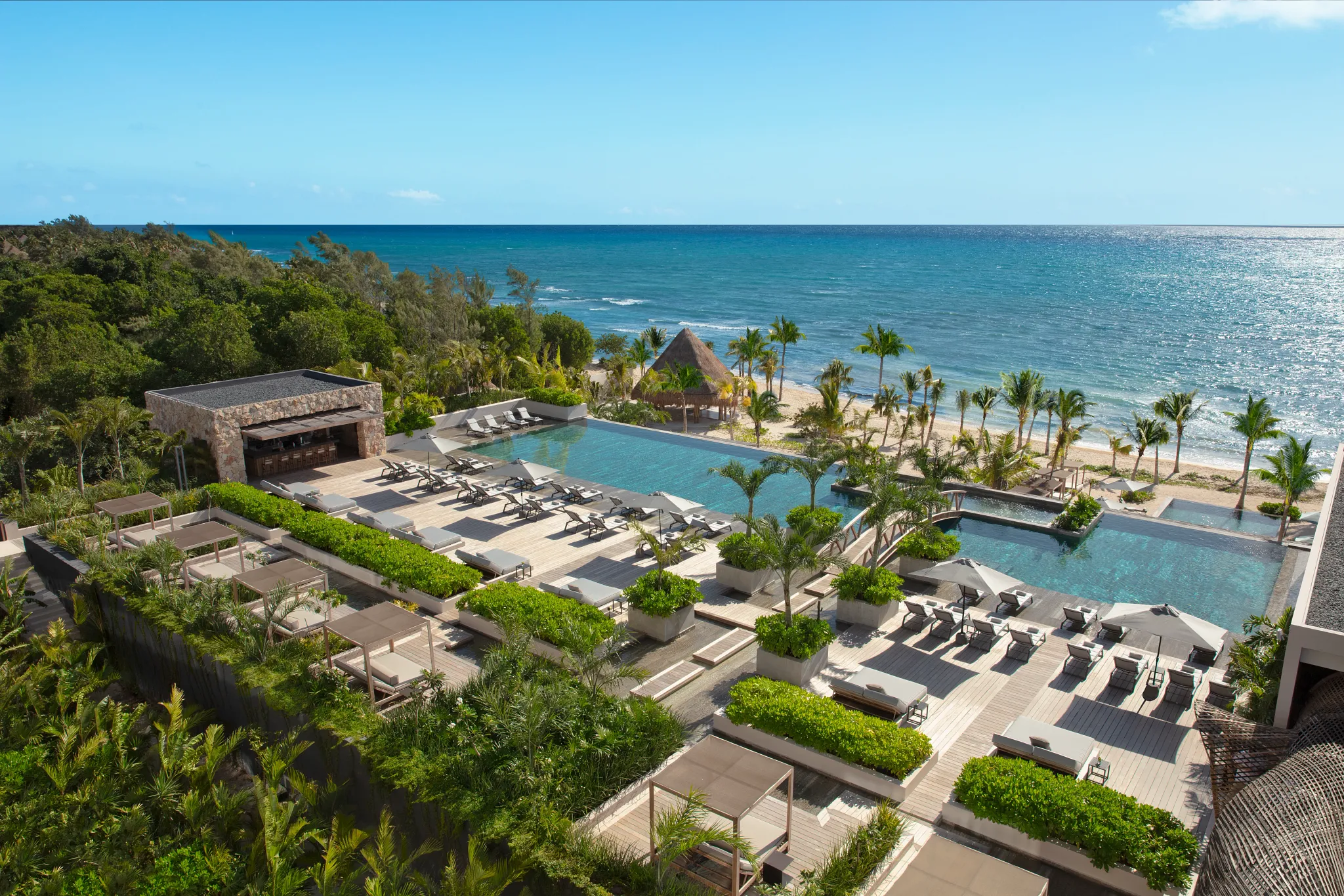 Aerial view of the main infinity pool overlooking the Caribbean Sea at Impression Moxché by Secrets in Playa del Carmen.