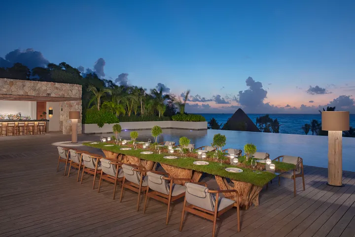Elegant private dinner setup overlooking the ocean at Impression Moxché by Secrets in Playa del Carmen.
