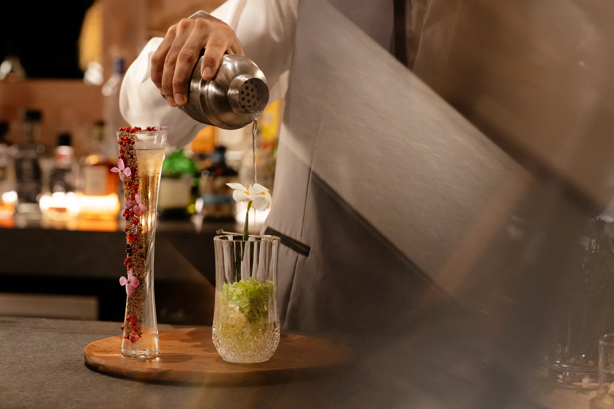 Bartender crafting an elegant handcrafted cocktail at Impression Moxché by Secrets in Playa del Carmen.