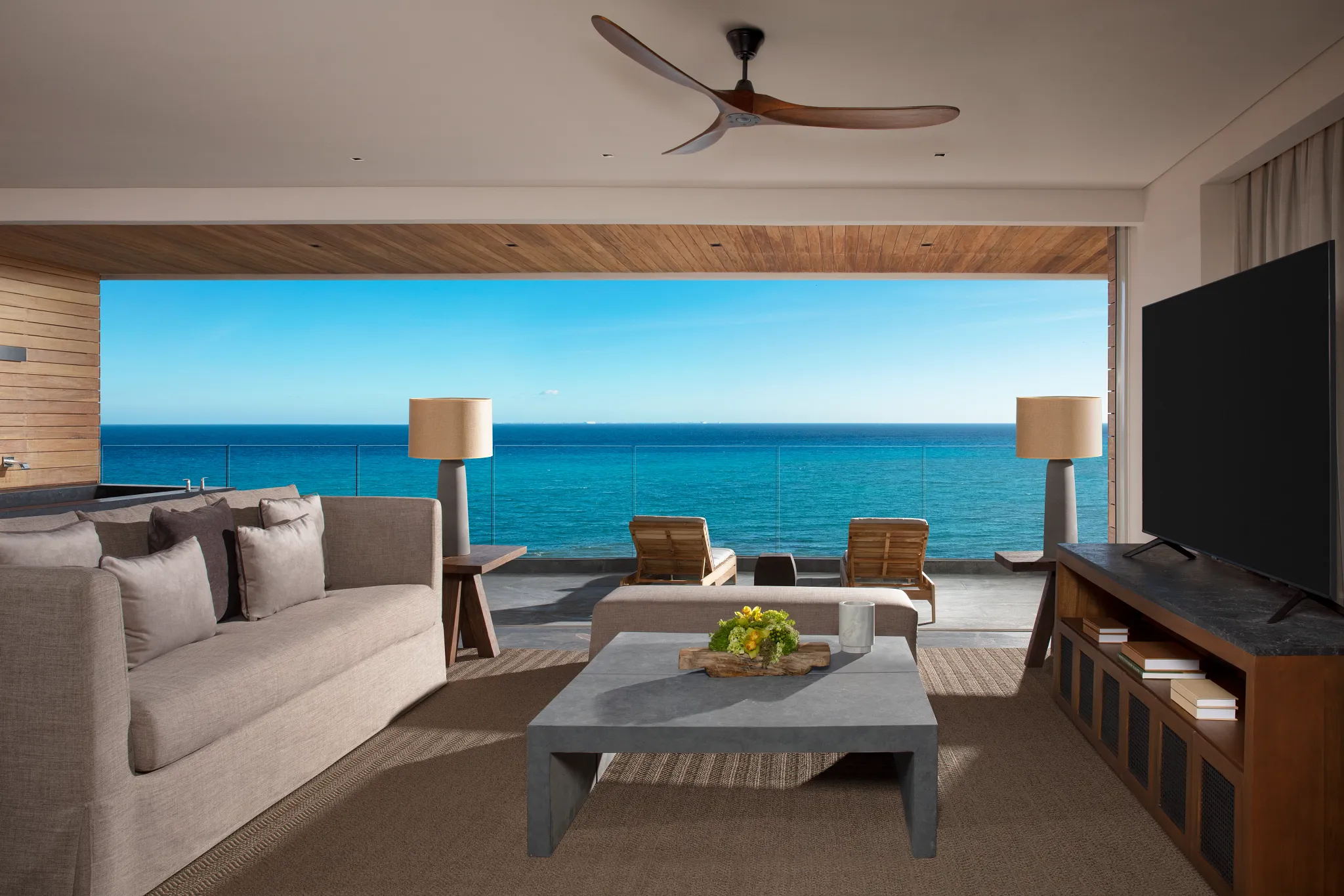 Panoramic Suite Ocean Front living room opening to private terrace at Impression Moxché by Secrets.