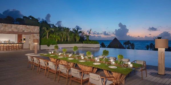 Pool Terrace oceanfront dinner setup at sunset for weddings at Secrets Impression Moxché