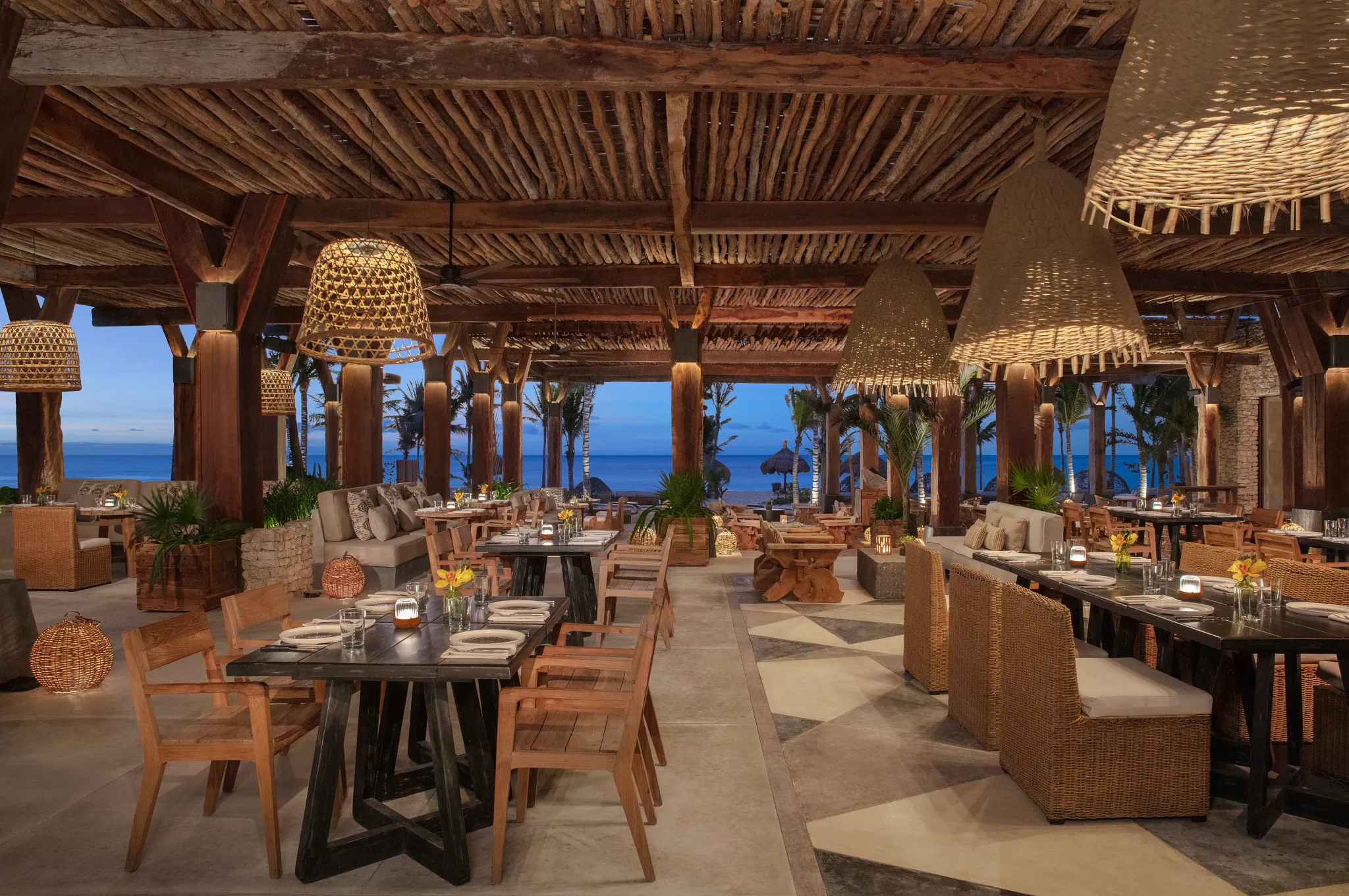 Seasoul oceanfront seafood restaurant at Impression Moxché by Secrets featuring open-air wooden design, woven pendant lighting, and beachfront views.
