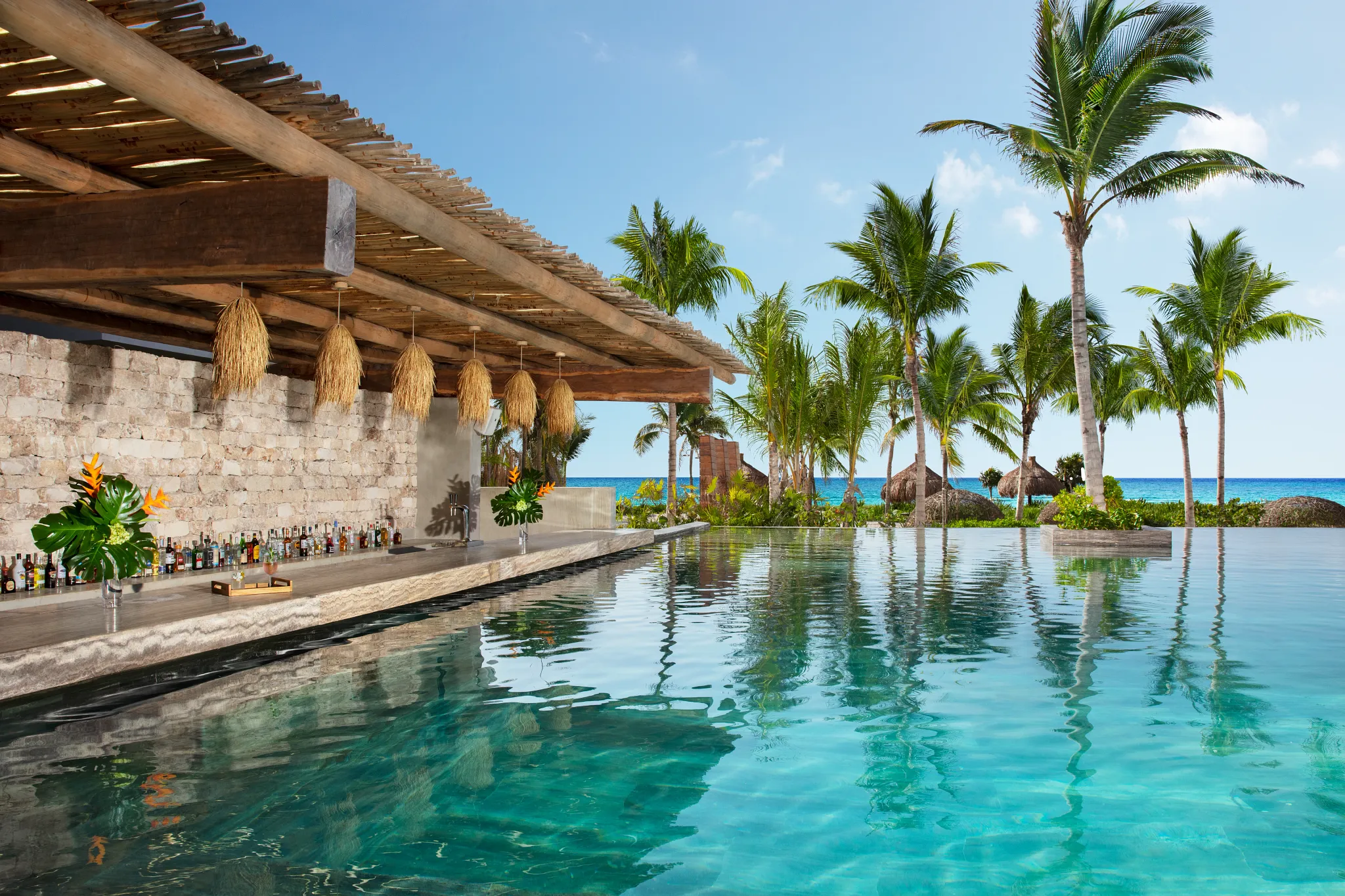 Sugar Reef swim-up bar at Impression Moxché by Secrets featuring infinity pool seating, ocean views, and tropical beachfront setting.