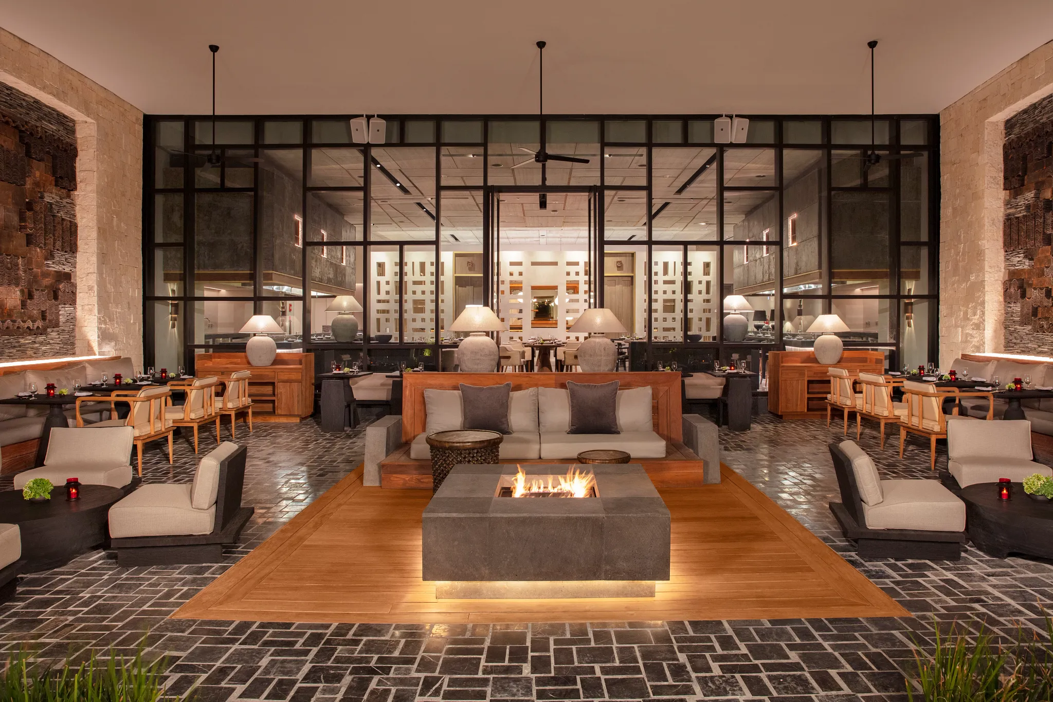 Suki Japanese fusion restaurant at Impression Moxché by Secrets featuring modern open-air terrace dining, teppanyaki tables, and contemporary décor.